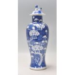 A late 19th Century Chinese blue and white prunus pattern baluster lidded vase, the lid having a foo