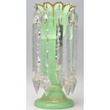 A 19th Century Victorian green glass lustre having a crenelated rim with gilt decoration central