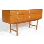 A mid century teak wood Danish influenced low sideboard chest credenza. Raised on turned legs with