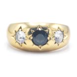 A hallmarked 9ct gold 3 stone ring. The ring set with a central blue sapphire flanked by 2 white