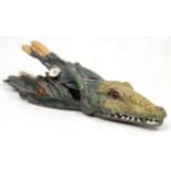 A cast bronze wall mounting paper clip in the form of an alligator and reeds, being cold painted and
