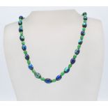 A vintage Art Deco 1930's glass beaded necklace having alternate 'peacock eye' foil beads and