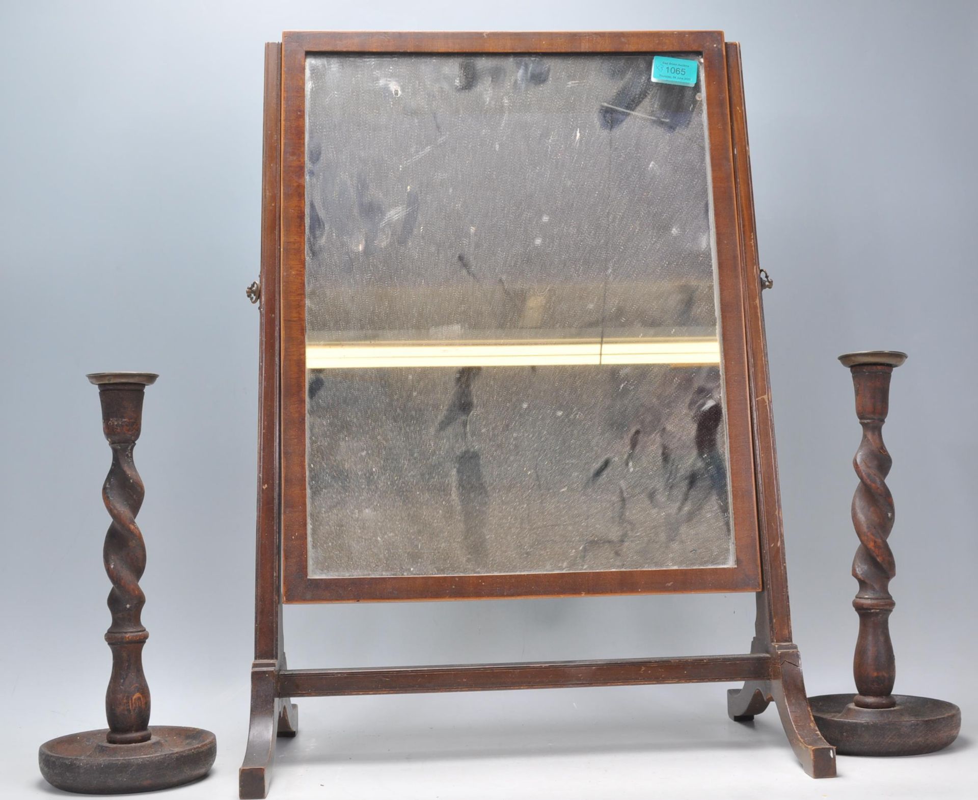 A 19th century George III mahogany toilet swing mirror of square form raised on a splayed leg