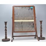 A 19th century George III mahogany toilet swing mirror of square form raised on a splayed leg