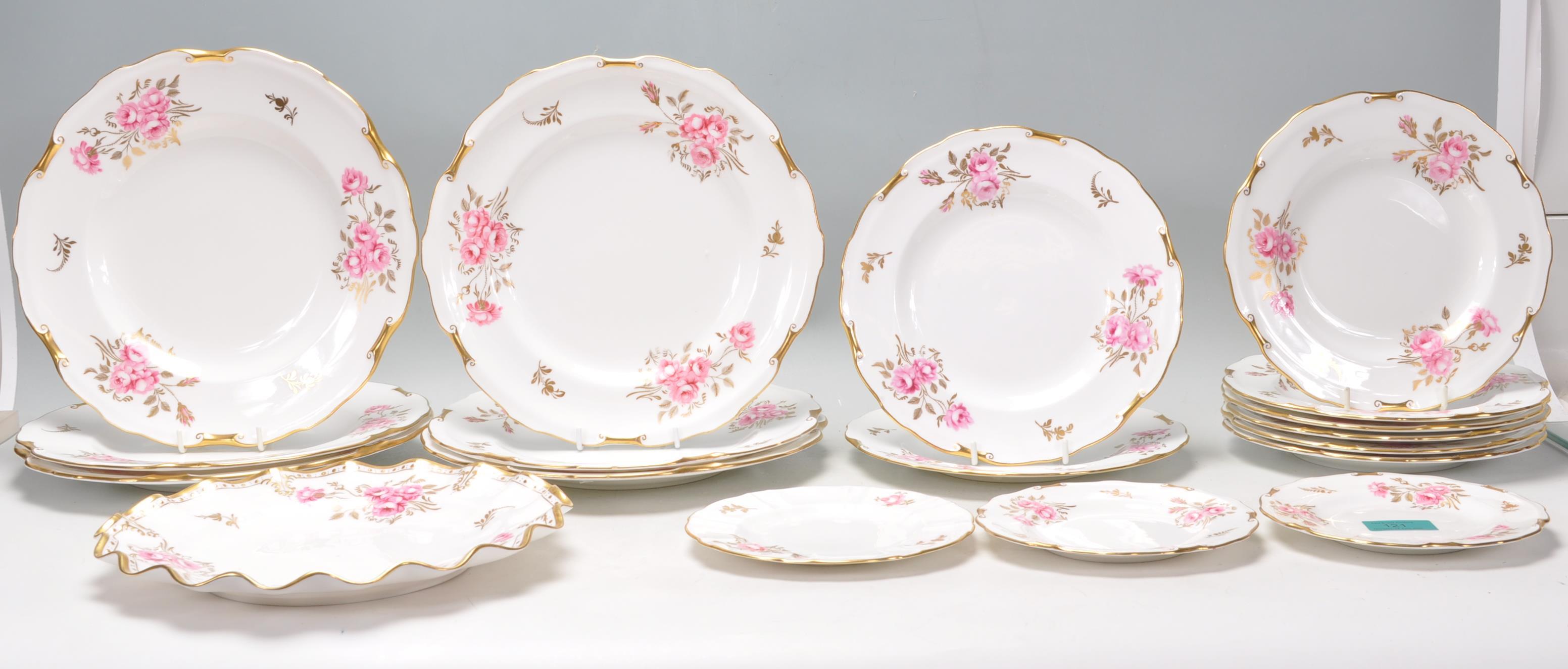 A group of Fine Bone English China plates by Royal Crown Derby in Pinxton Roses pattern with hand