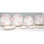 A group of Fine Bone English China plates by Royal Crown Derby in Pinxton Roses pattern with hand