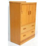 A 1920's Art Deco walnut tallboy - linen cupboard raised on a plinth base with a cupboard raised