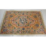 A 20th Century crewel work embroidery wall hanging having a floral bordered design around a