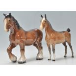 A  collection of 2 Beswick horse porcelain figurines to include a bay coloured shire horse and a bay