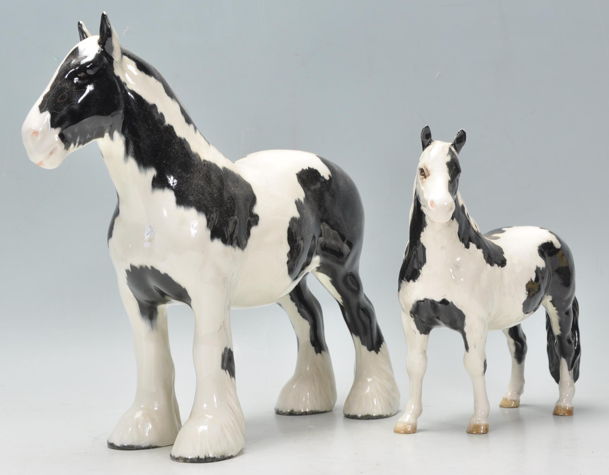 A  collection of Beswick horse porcelain figurines to include a piebald coloured shire horse and a