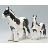 A  collection of Beswick horse porcelain figurines to include a piebald coloured shire horse and a