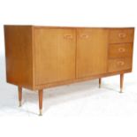 A mid century Danish influenced teak wood sideboard credenza. The sideboard raised on turned legs