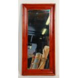 A 20th Century wooden framed rectangular wall mirror having a chamfered dark stained pine wood