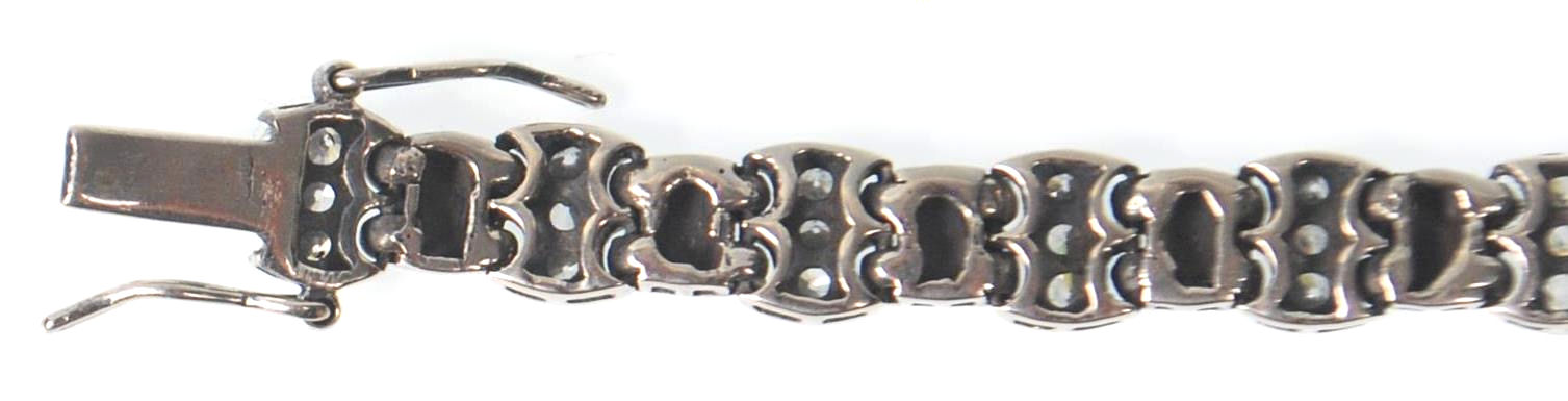 A ladies stamped 925 silver line bracelet being set with three round cut CZ stones with a tongue - Image 5 of 7