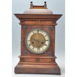 A good late 19th / early 20th Century oak cased German mantel clock having a decorative carved