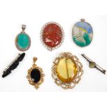 A group of seven ladies brooches and pendants to include a rolled gold pendant set with a black
