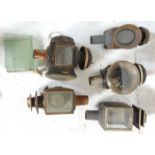 A mixed group of five antique carriage lamps of varying sizes with most still having their glass