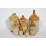 A collection of 19th Century local interest stoneware flagons including makers such as W. B.