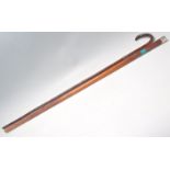 Two 19th Century antique walking stick canes to include a wooden cane with a silver top having