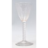 An 18th Century Georgian glass wine goblet having a tapering bowl with an air twist design stem with