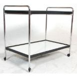 A vintage retro 20th Century drinks / tea trolley having tubular chrome supports with a two tiers of