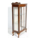 A 1930's Art Deco mahogany Queen Anne revival display china cabinet vitrine being raised cabriole