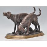 A vintage 20th Century bronze figure depicting a two hunting dogs. Raised on a rounded base.