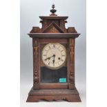 A late 19th century Victorian 8 day mantel clock. The oak case with spire top having inset brass and