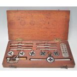 A vintage wooden cased bolt tool set including taps and die's of different sizes, set complete in