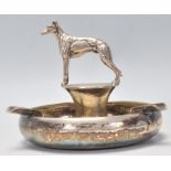 Hunting Interest. An early 20th Century silverplated ashtray having bowl to base with twin cigarette