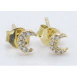 A pair of 18ct gold stud earrings having crescent mood heads set with diamond accent stones.