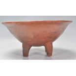 An early 20th Century African terracotta studio bowl raised on four feet.