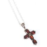 A stamped 925 silver pedant necklace having a crucifix pendant set with oval cut red stones on a