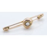 A good 9ct yellow gold brooch having a central shell set with a seed pearl. Stamped 9ct. Within a