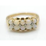 A hallmarked 9ct gold opal and diamond cluster ring. The ring set with opal cabochons with diamond