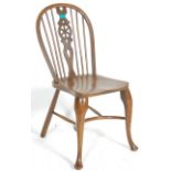 A 19th Century Victorian antique wheel back side chair having a pierced wheel splat with rail back