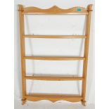 A vintage 20th Century elm wall mounting plate display rack having four bow front shelves with a