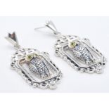 A pair of ladies stamped 925 silver stud drop earrings in the form of perched owls within frames