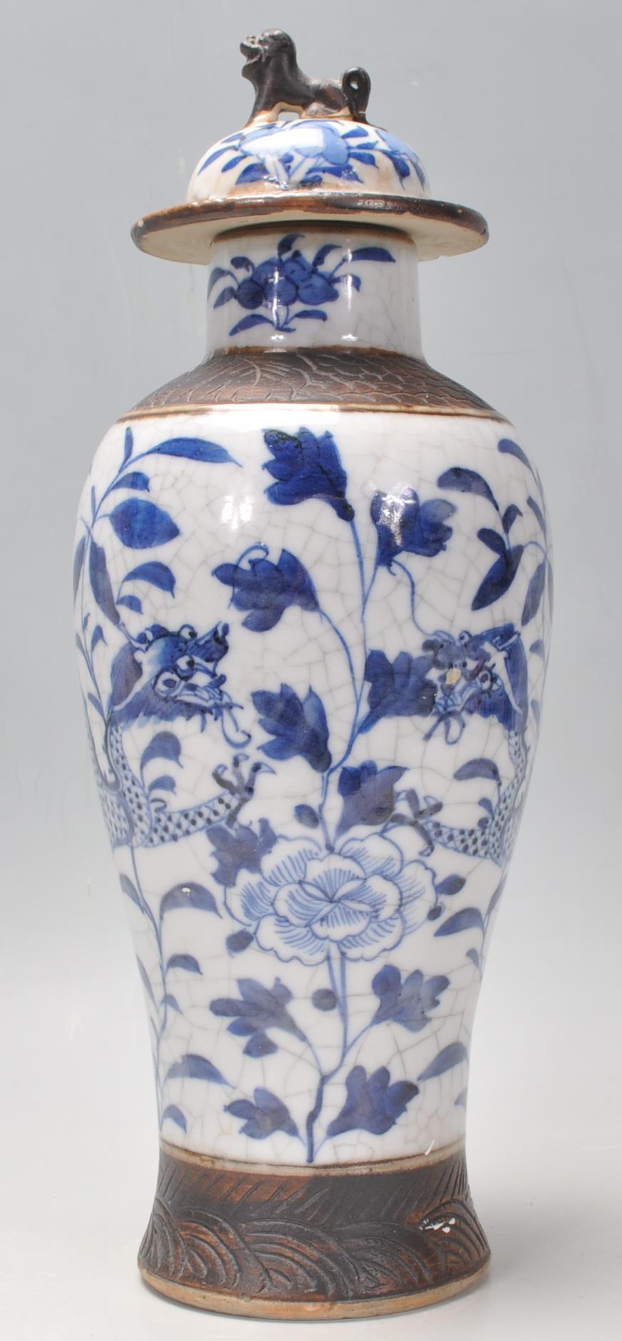 A late 19th Century Chinese blue and white lidded crackle glaze baluster vase having hand painted