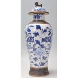 A late 19th Century Chinese blue and white lidded crackle glaze baluster vase having hand painted
