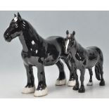 A  collection of 2 Beswick horse porcelain figurines to include a black  coloured shire horse with