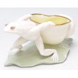 A 19th century Victorian table salt in the form of a frog hauling a sea shell being raised onto a