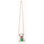 A silver bug necklace in the form of a beetle having a green stone back with marcasite and red stone