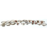 A collection of twenty vintage silver rings to include a selection of rings set with red stones, a