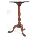 A 19th Century antique mahogany wine table having a round top raised on a turned knopped column with