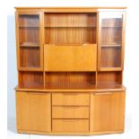 A retro 20th Century Sakol teak room unit having three central drawers to the lower section