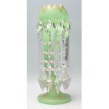 A 19th Century Victorian green glass mantle piece lustre of tulip form having a crenelated rim,