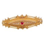 An early 20th Century 9ct gold hallmarked mourning brooch set with a single red gemstone flanked