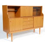 A retro 1970's teak veneered highboard / sideboard credenza having a glazed and concealed cabinet