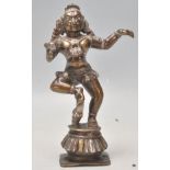 A good 20th Century Indian bronze figure depicting Krishna as Balakrishna dancing with his right leg